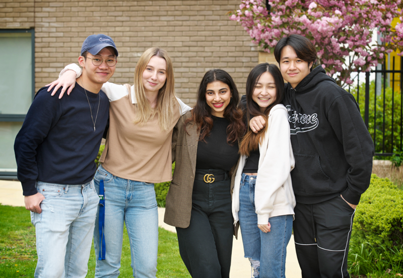 Male And Female Students Pose For A Photo At Abbey College Cambridge